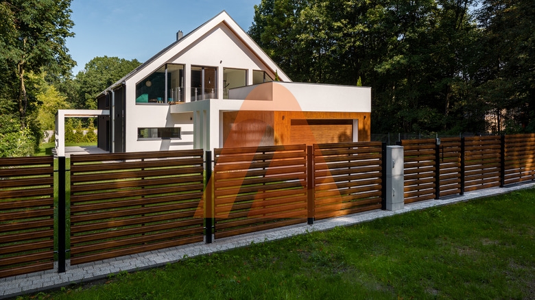 Spacious,White,House,With,Wooden,Decoration,On,Garage,And,Wood | How to Enhance Curb Appeal with Residential Fencing | Aluglobusfence.com